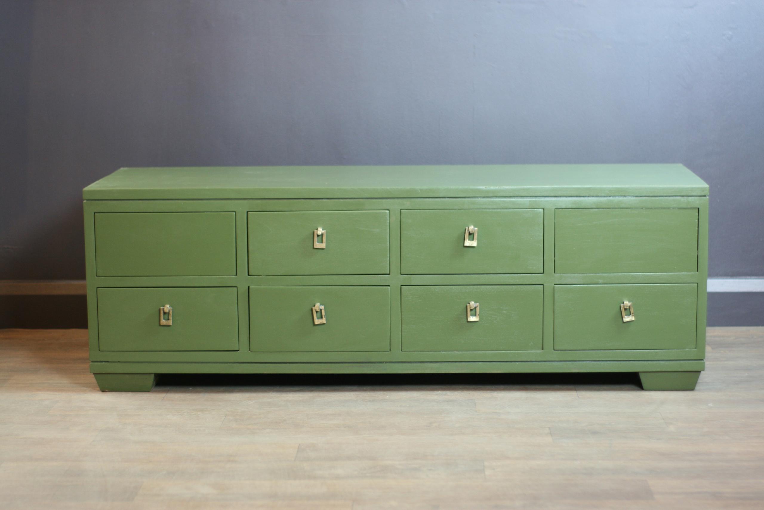 This 6 drawer, Green coffee table was stripped back and painted by hand, in our London based workshop, using 'Olive Green' paint and clear varnish. 2 drawers are not useable- the ones without handles.