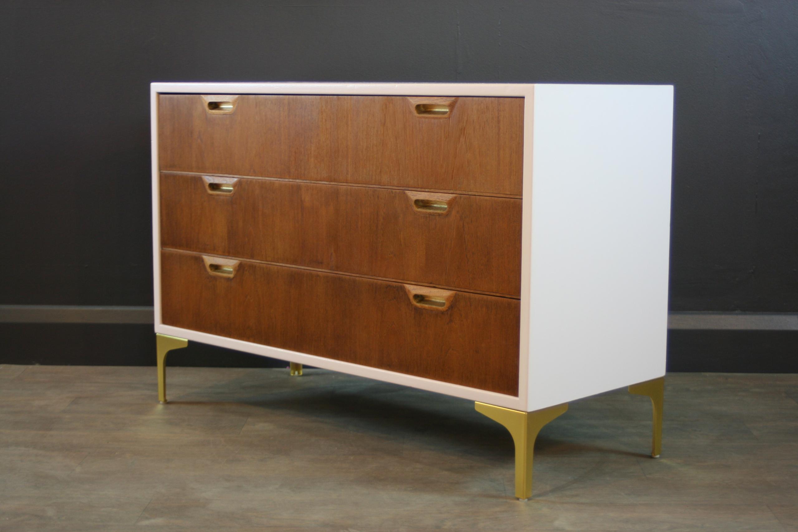 This Pink mid century style chest of drawers was upcycled in our London based workshop. We've added new Gold colour metal legs.
