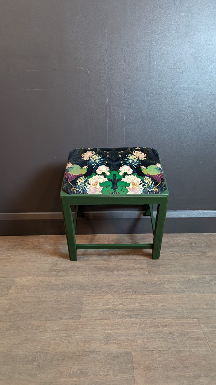 This charming upholstered stool has been meticulously cleaned, painted, and reupholstered in our London-based workshop. Featuring 'Dartmoor Deep' Green paint and luxurious Wendy Morrison 'Phoenix Black' Cotton Velvet Fabric, it’s a stunning combination of sustainability and timeless design.