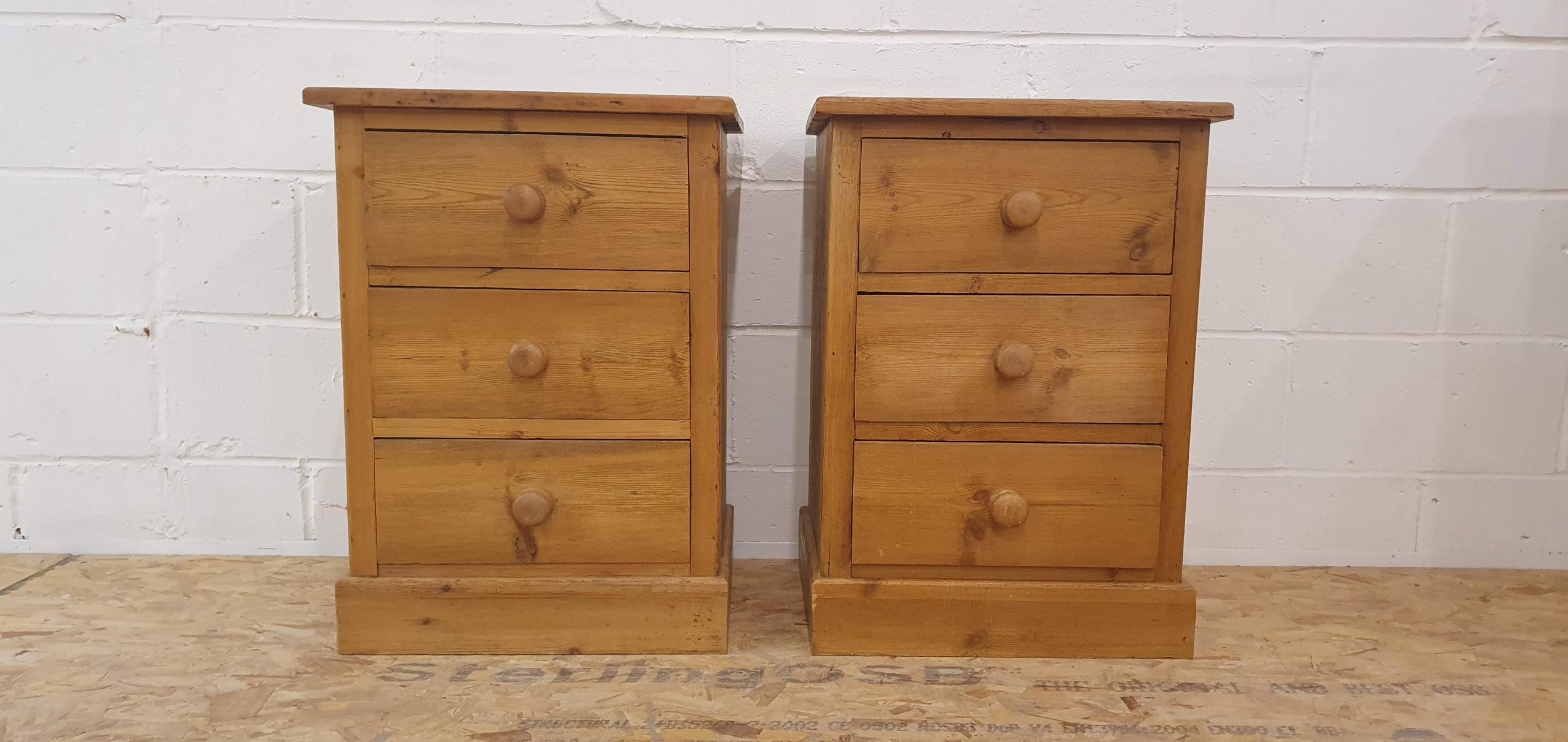 A timeless pair of farmhouse style solid pine bedside cabinets featuring three drawers each and traditional wooden knobs.