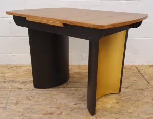 This solid wood Art Deco style dining table comfortably seats four, providing a sturdy and reliable surface for everyday use. Restored medium wood top, black frame and Gold leaf on the inside of the two semicircle legs